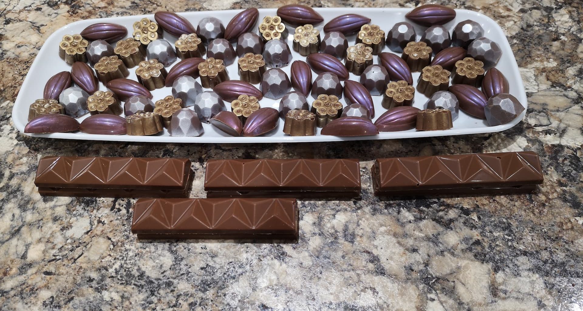 a rectangular white plate with chocolates on it